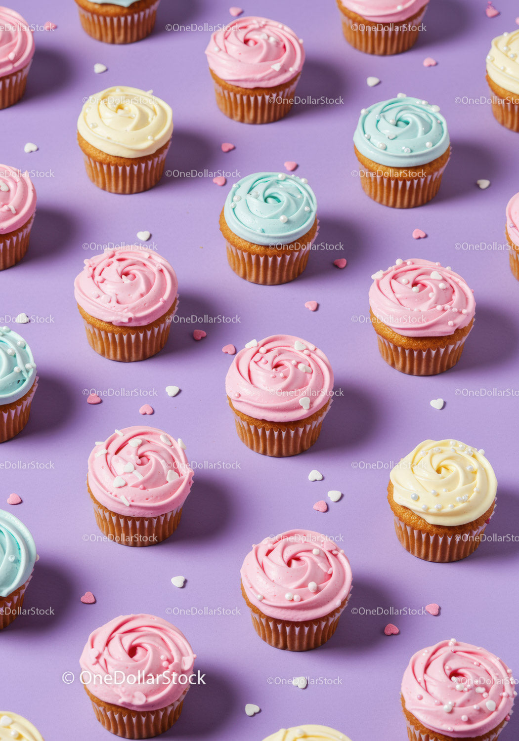 Colorful cupcakes with pastel frosting on purple background