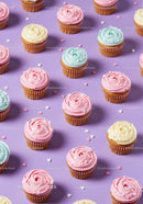 Colorful cupcakes with pastel frosting on purple background