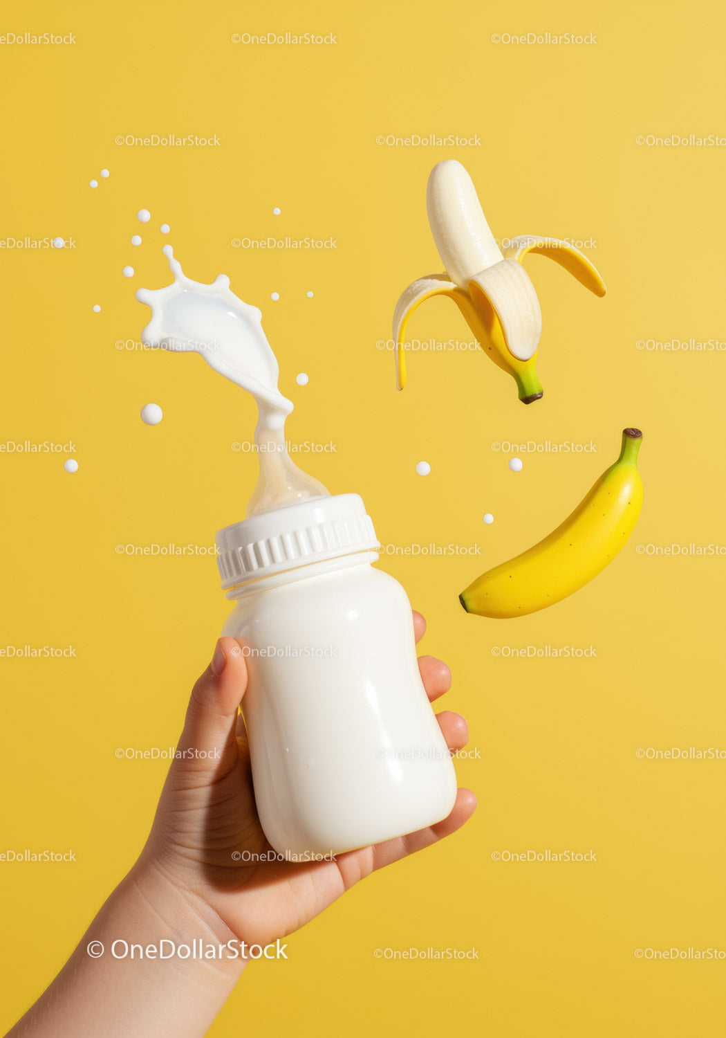 Ręka trzymająca butelkę dla dziecka z rozpryskującym się mlekiem i bananami