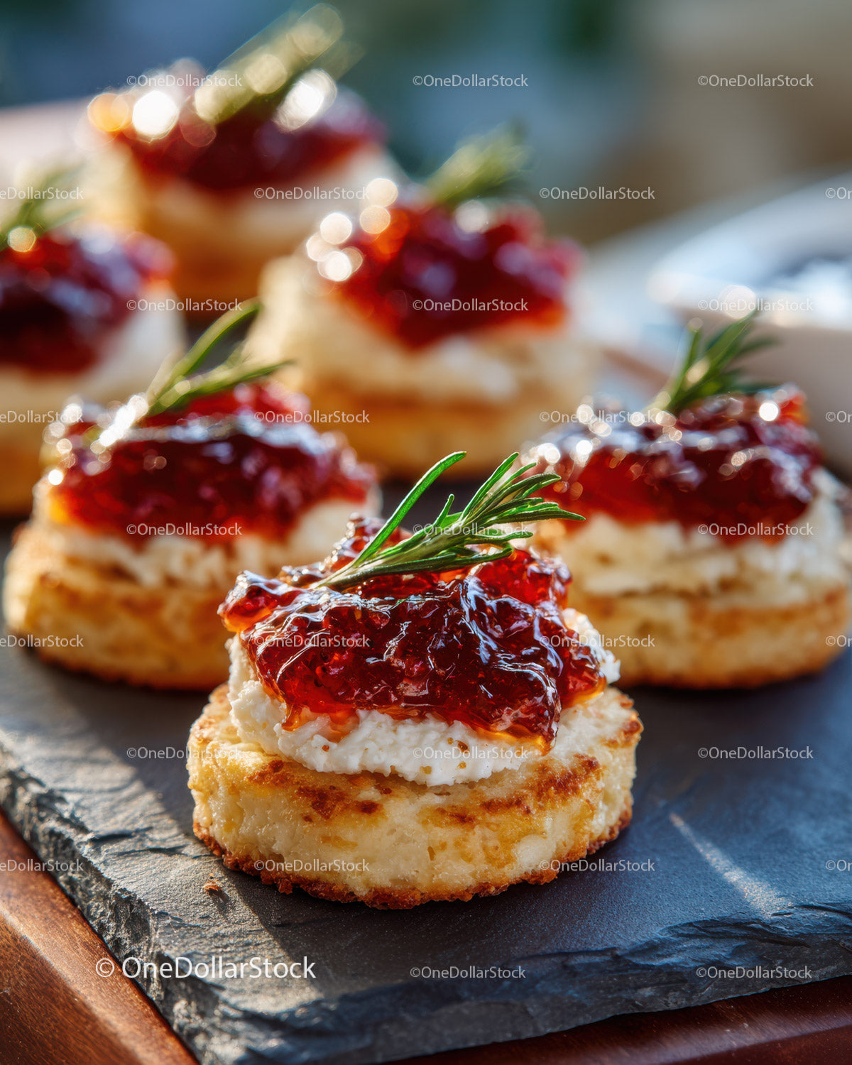 Potato Pancakes with Sour Cream and Strawberry Jam Garnished with Rosemary