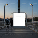 Empty billboard on urban bridge at dusk with two joggers