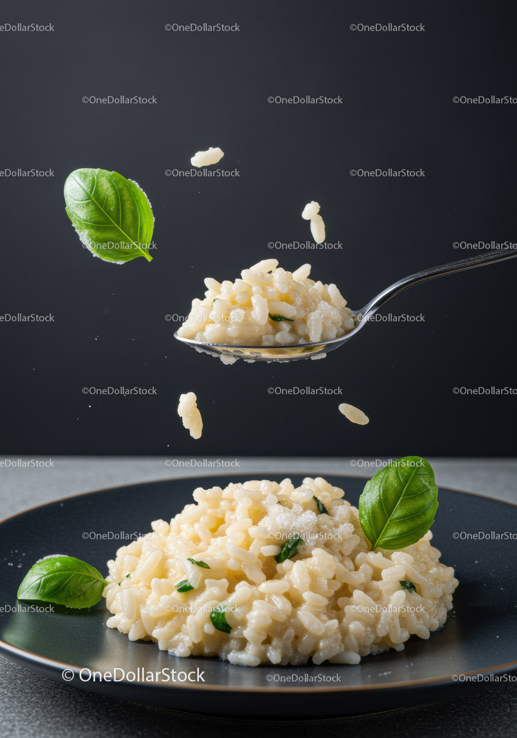 Creamy risotto with fresh basil leaves on dark plate