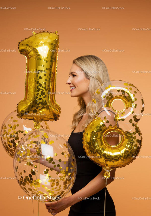 Smiling woman celebrating eighteenth birthday with balloons