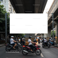 Busy urban street with motorcycles under elevated highway