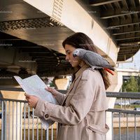 Woman with African Grey Parrot Reading Map Outdoors