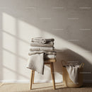 Minimalist cozy towels stacked on wooden stool and basket