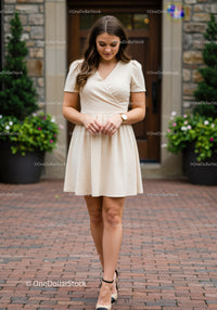 Elegant Young Woman Walking Outdoors in Summer Beige Dress