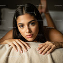 Young Woman Lying on Cozy Beige Blanket with Beautiful Eyes and Natural Makeup