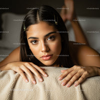 Young Woman Lying on Cozy Beige Blanket with Beautiful Eyes and Natural Makeup