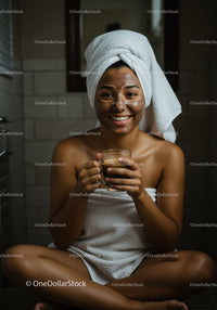 Young Woman Enjoying Facial Mask and Hot Drink in Cozy Spa Setting