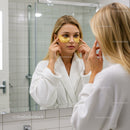 Young Woman Applying Under-Eye Patches in Skincare Routine