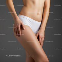 Toned Female Body in Underwear with Artistic Lighting and Neutral Background