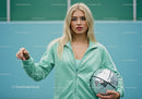 Young Woman in Mint Green Tracksuit Holding Disco Ball in Studio