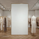Minimalist fashion boutique with neutral clothing display