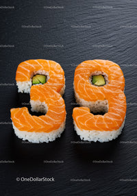 Sushi Rolls Shaped as Numbers Thirty Nine on Black Plate