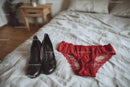 Chic Black Heels and a Red Lace Dress in a Cozy Bedroom Setting