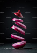 Floating Slices of Fresh Red Onion on Dark Background