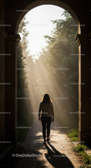 Woman walking through sunlit garden archway
