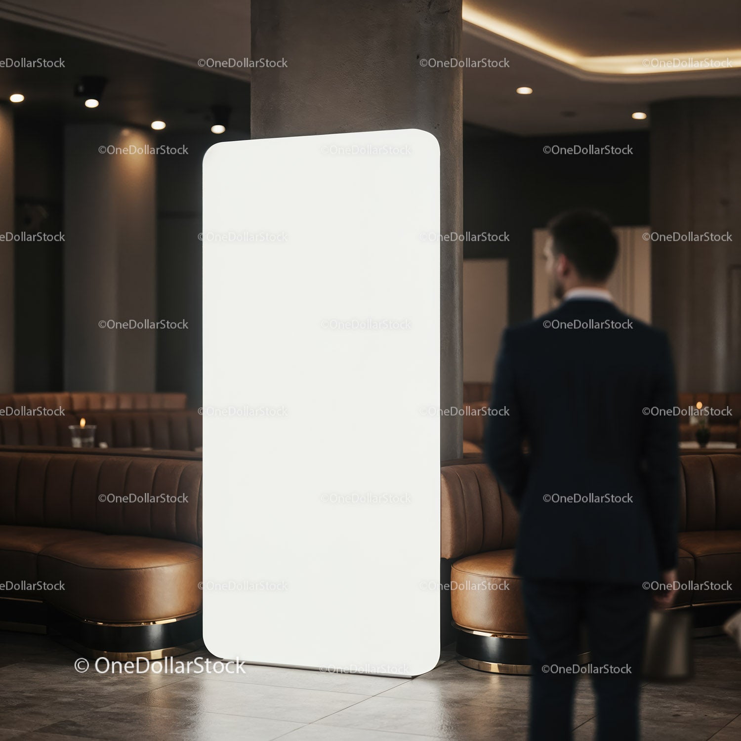 Businessman in suit standing near blank digital billboard