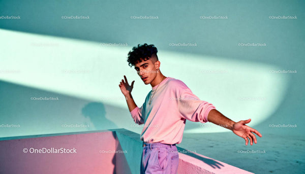 Young man expressing creativity in pastel outdoor setting
