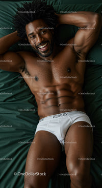 Smiling muscular man relaxing on bed in white underwear