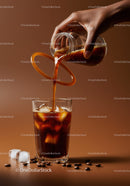 Refreshing Iced Coffee Poured from Glass Jug with Beans