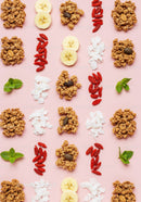 Healthy breakfast ingredients neatly arranged on pink background