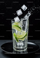 Refreshing sparkling water with lime and ice cubes splash