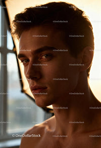 Natural light portrait of young man with calm expression