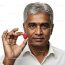 Mature Man Holding Raspberry with Calm Expression in Studio