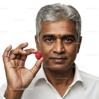 Mature Man Holding Raspberry with Calm Expression in Studio