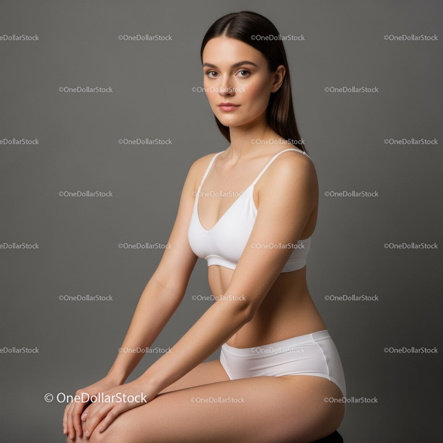 Elegant Young Woman in White Casual Outfit in Gray Studio