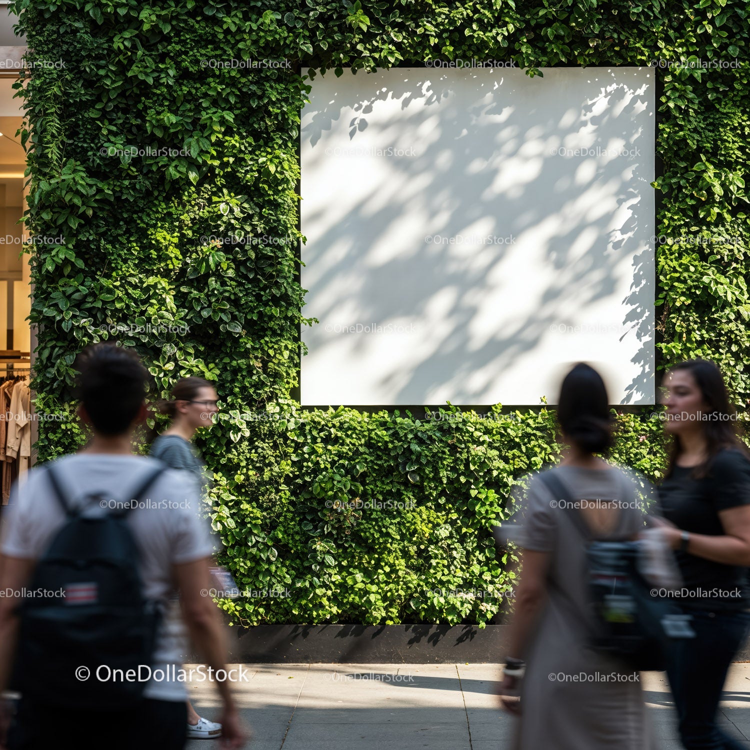 Blank white billboard on lush green vertical garden wall