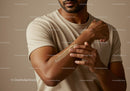 Close-Up of a Man Applying Lotion to Arm for Skincare Routine