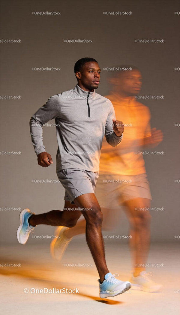 Focused man jogging indoors in light sportswear