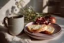 Coffee Cup with Sliced Bread and Pomegranate on Rustic Table