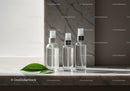 Minimalist clear spray bottles on marble surface
