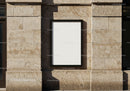 Blank vertical poster on textured stone wall facade