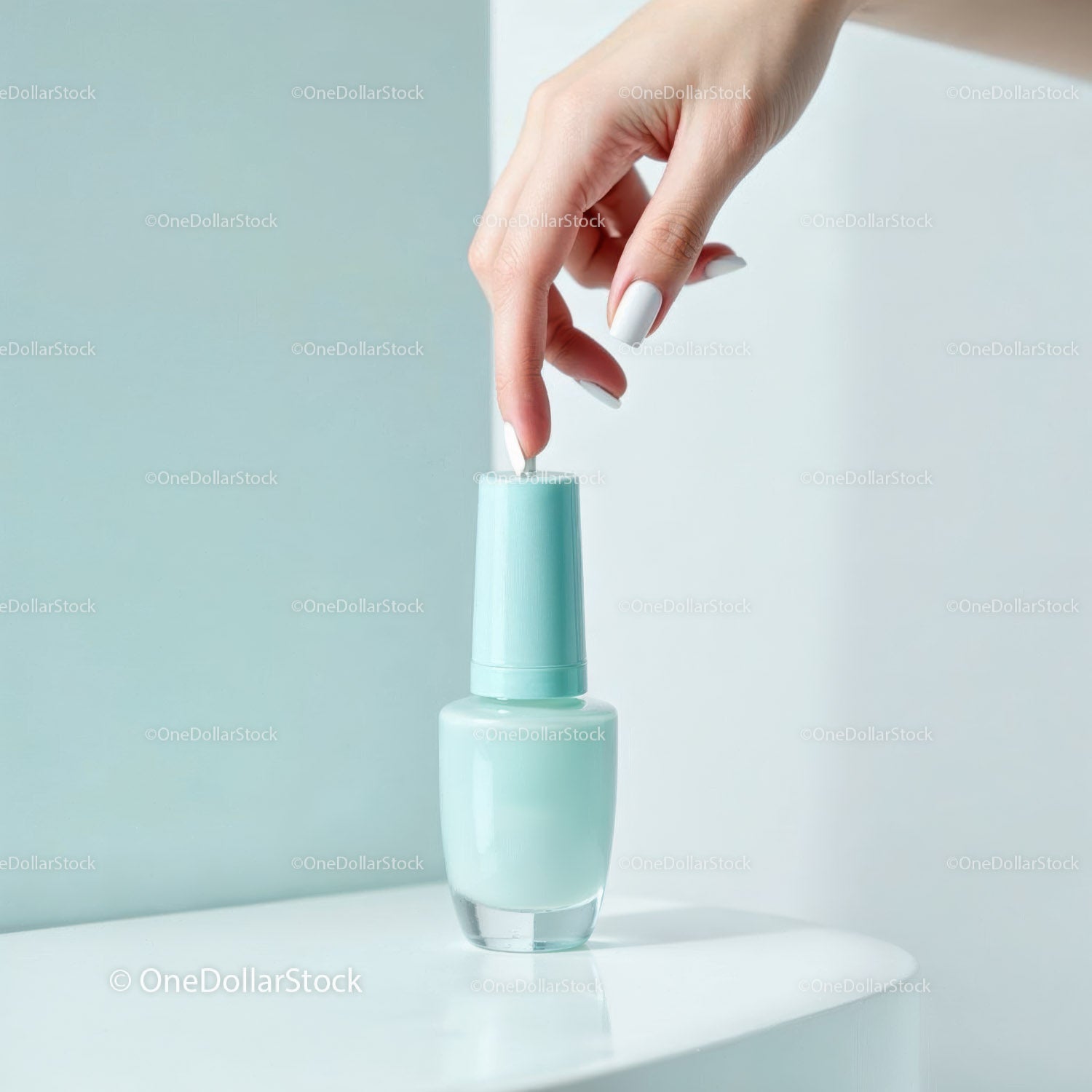 Light Teal Nail Polish Bottle with Manicure Hand