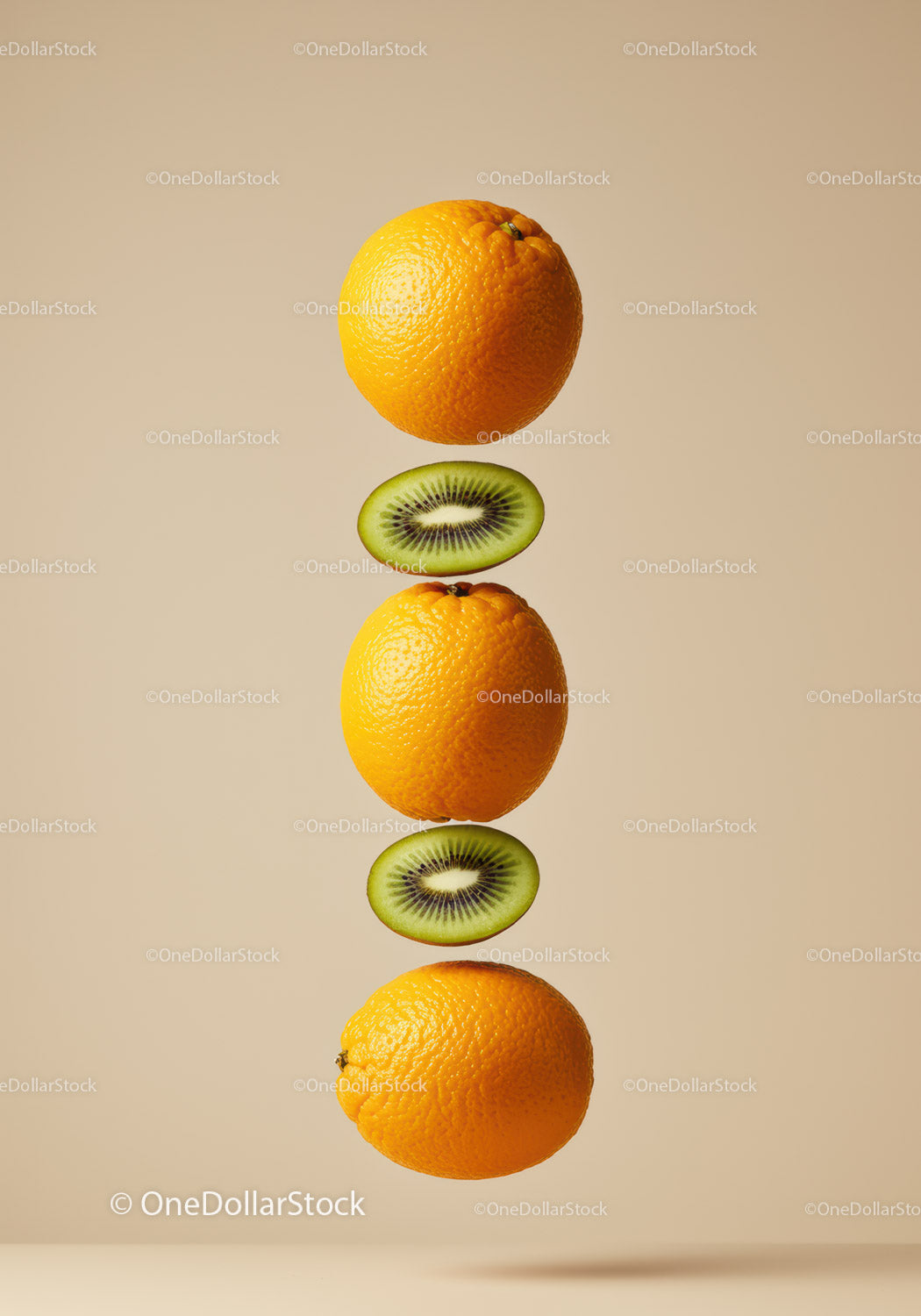 Stacked fresh oranges and kiwi slices on beige background