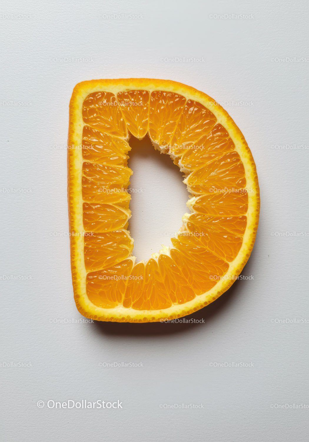 Fresh orange slice shaped like letter D on white background
