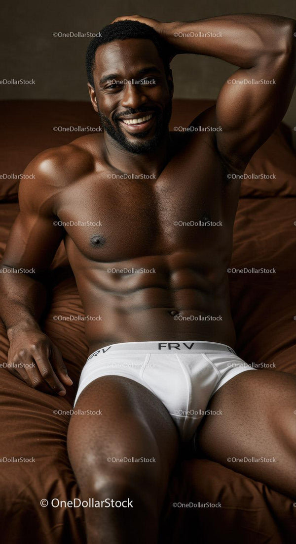 Smiling muscular man relaxing on bed in white underwear