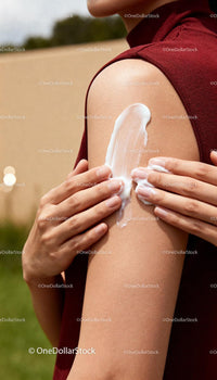 Woman Applying Moisturizer on Smooth Shoulder Skin