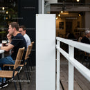 Quiet coffee shop patio with thoughtful patrons outdoors