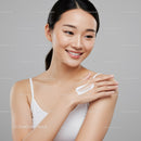 Young Woman Applying Facial Moisturizer for Glowing Skin
