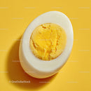 Close-up of a Hard Boiled Egg Cut in Half on Yellow Background