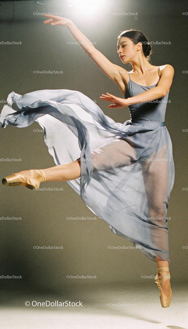 Graceful ballet dancer performing elegant jump pose