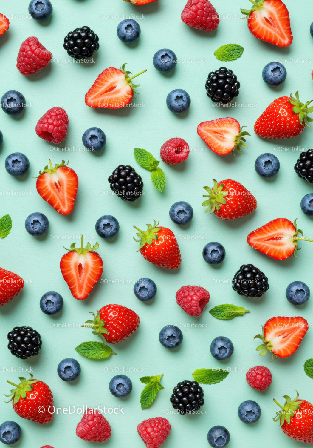 Fresh Mixed Berries with Mint Leaves on Blue Background