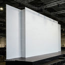 Empty white stage with large backdrops in auditorium