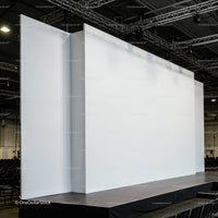 Empty white stage with large backdrops in auditorium